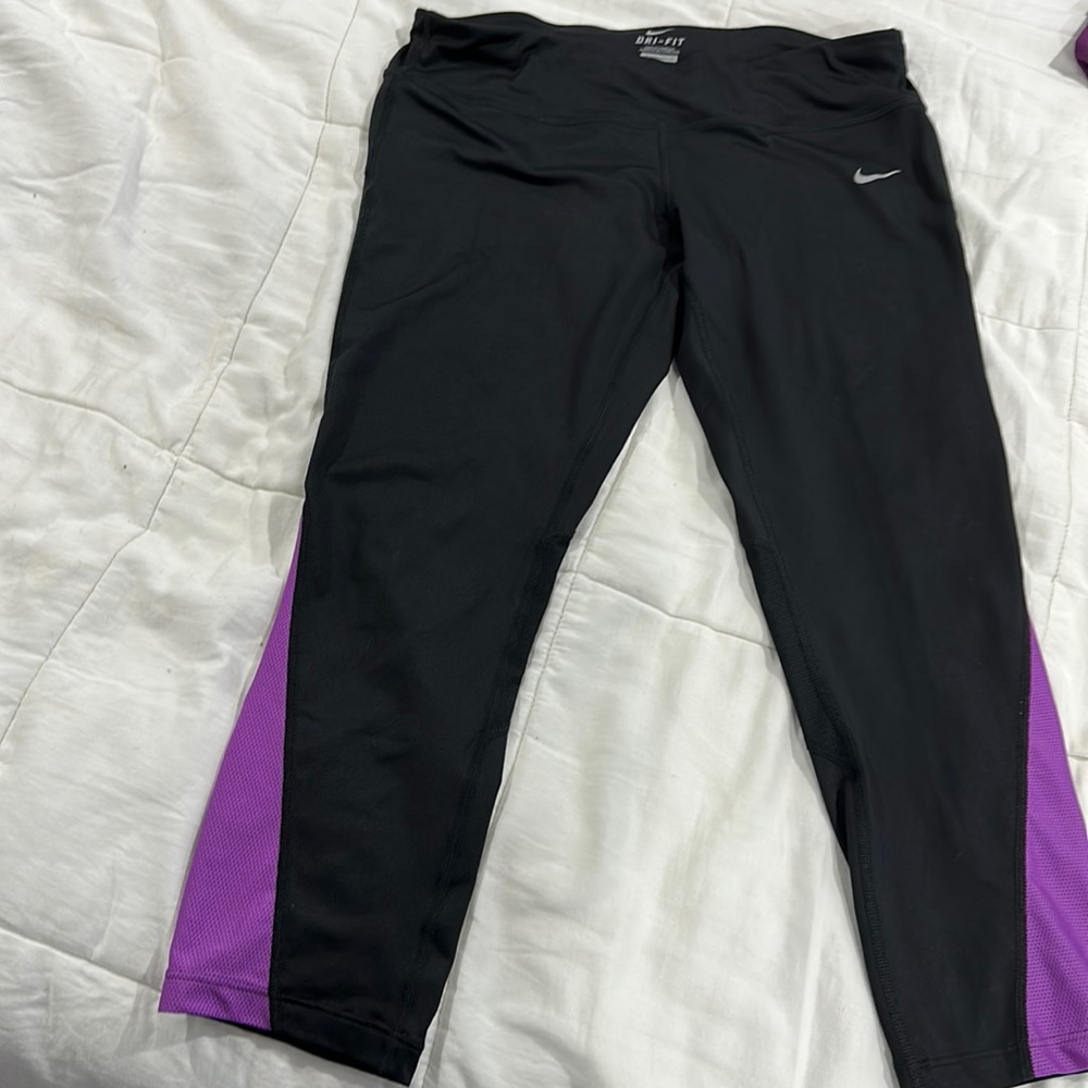 Nike black and purple cropped running leggings .